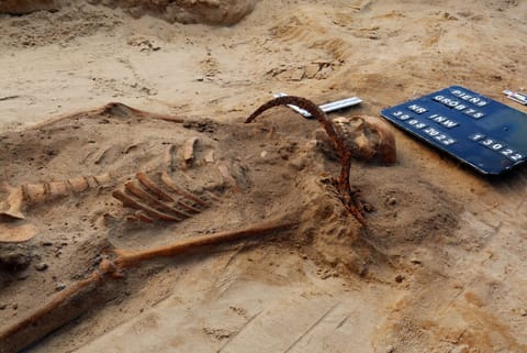 The true reasoning behind this undead-decapitating sickle burial is likely lost to time